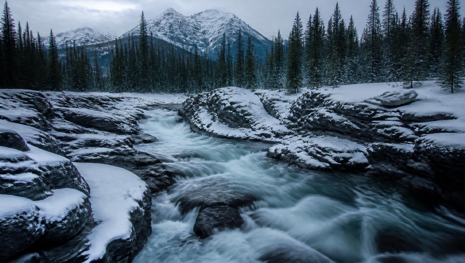A cold northern Canadian river running through snow and dark rock